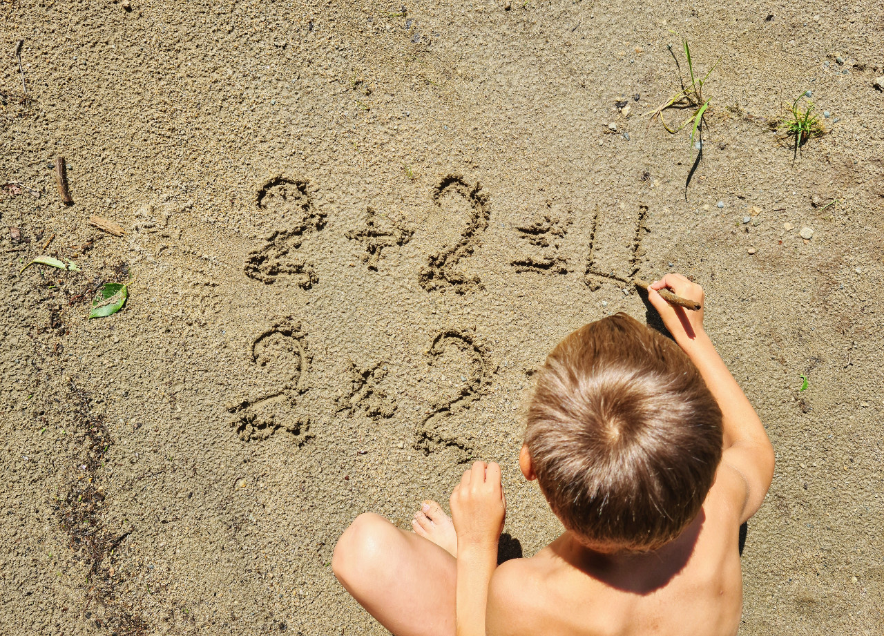 child writes numbers in the sand 2025 01 07 18 16 56 utc